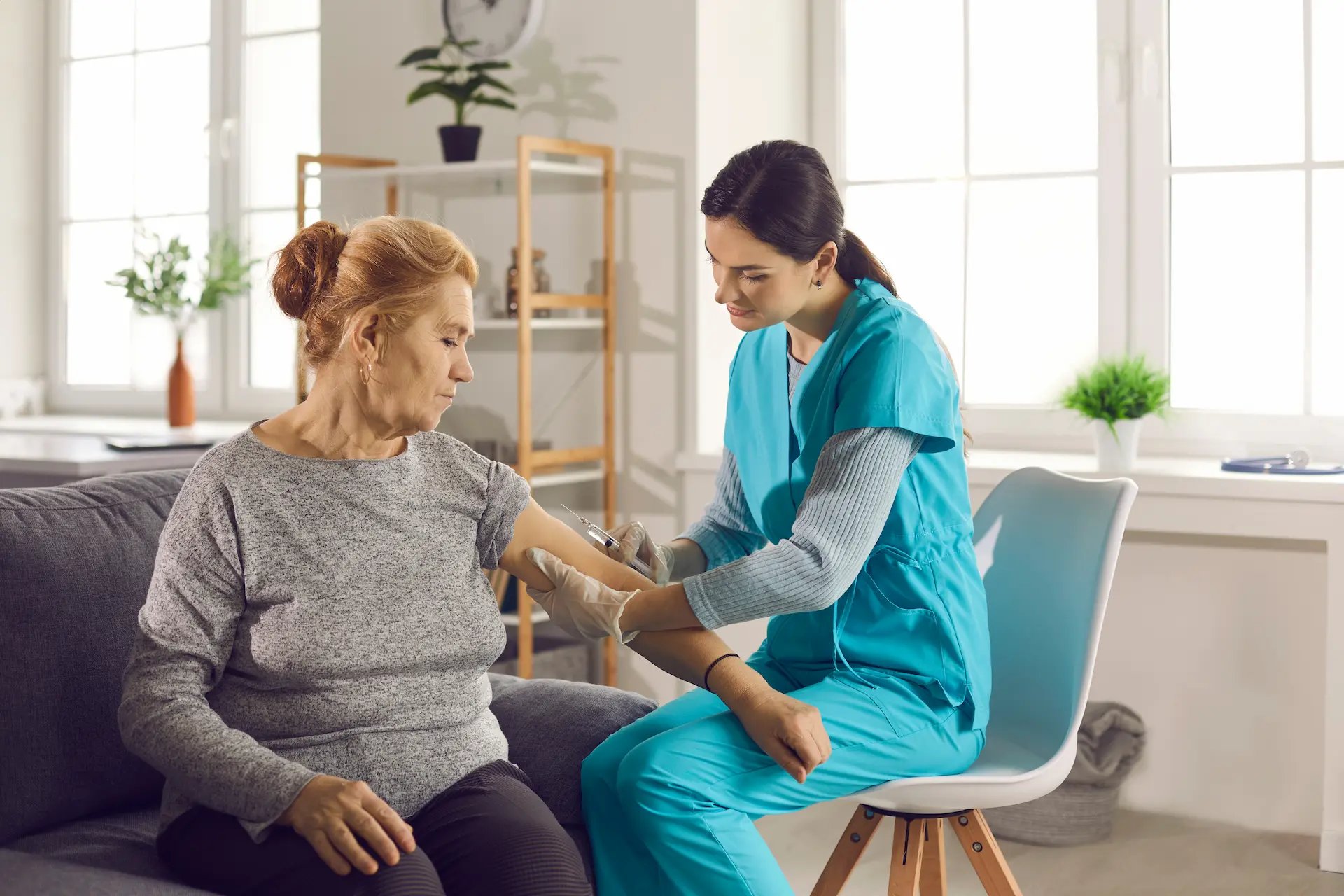 Enfermera atendiendo a una mujer mayor